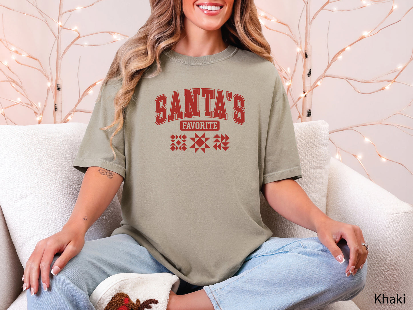 Festive Khaki t-shirt with the phrase “Santa’s Favorite” in red varsity letters and three quilt block designs, styled for quilters who love Christmas and handmade gifts.
