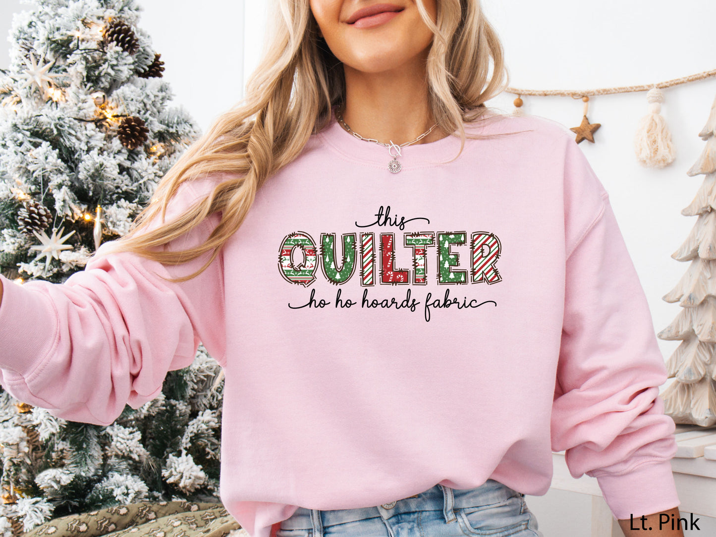 Cozy sweatshirt with playful patchwork lettering that says “This Quilter Ho Ho Hoards Fabric” — festive Christmas gift for quilters and sewing enthusiasts.