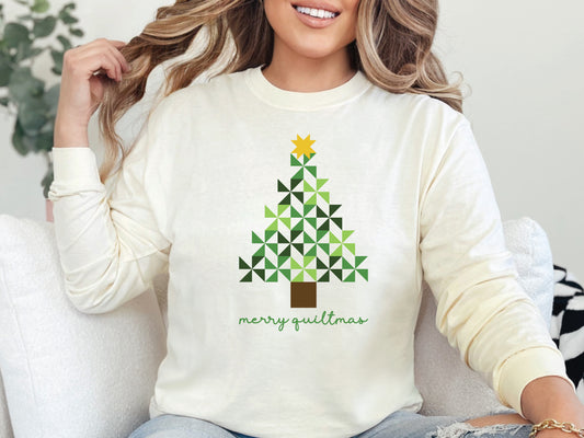 Merry Quiltmas long sleeve t-shirt in Ivory with quilt block Christmas tree design in green pinwheel blocks topped with gold star—holiday gift for quilters. Shop at Bee Inspired Tees for sewing and quilt-themed short and long sleeve t-shirts, gifts, and stickers designed for passionate sewists and quilters.