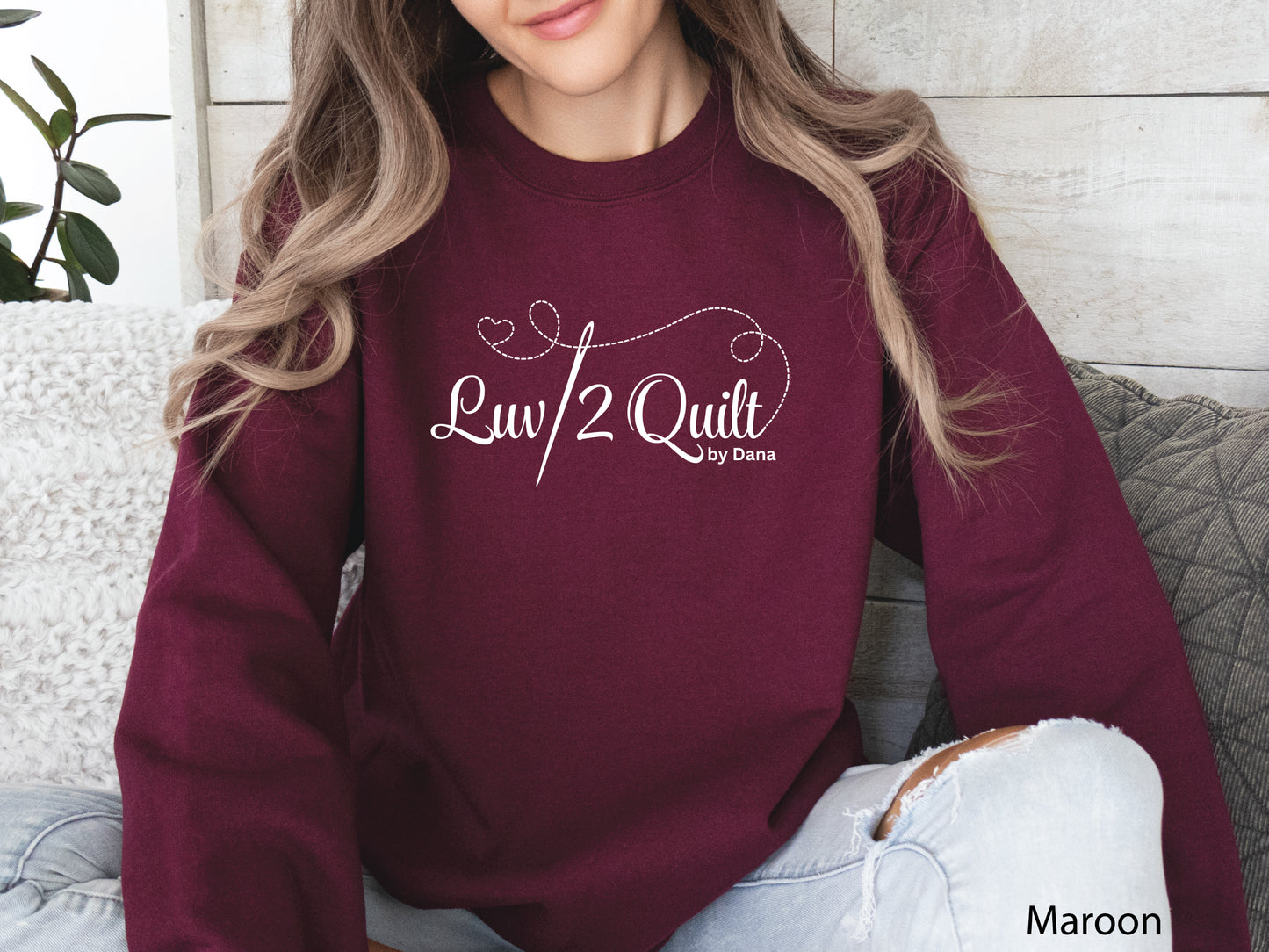 Official Luv2Quilt by Dana quilting-themed sweatshirt featuring the Luv2Quilt logo with a sewing needle and stitched heart design, perfect for quilt classes, retreats, and everyday wear.