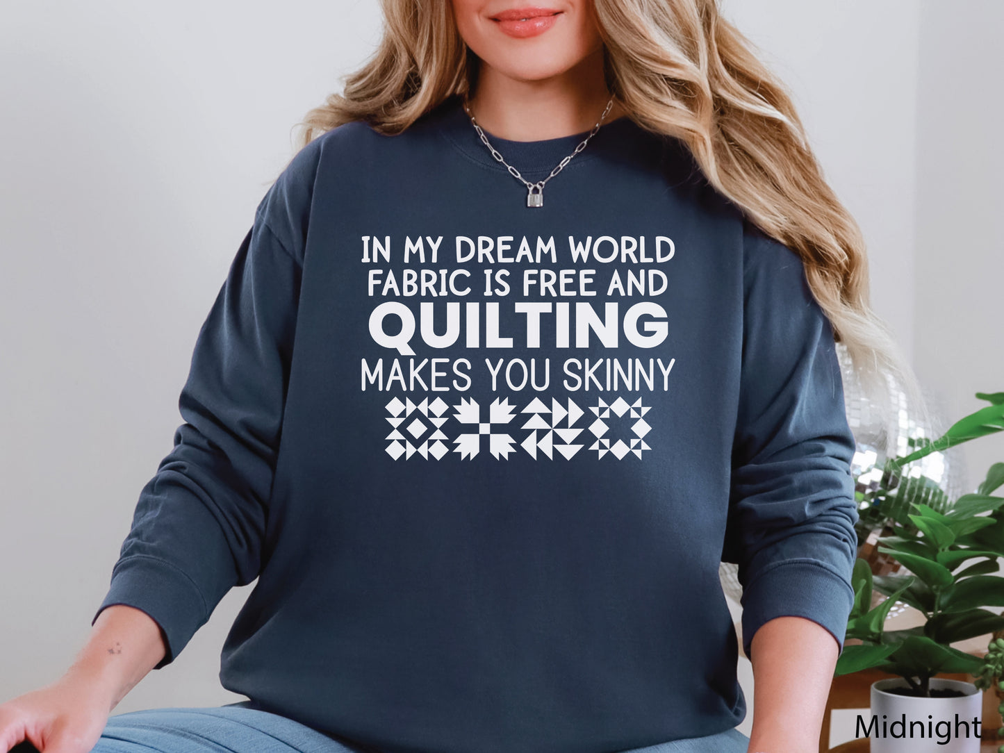 Funny quilter sweatshirt with the phrase “In My Dream World, Fabric Is Free and Quilting Makes You Skinny,” featuring quilt block designs and cozy long sleeves.