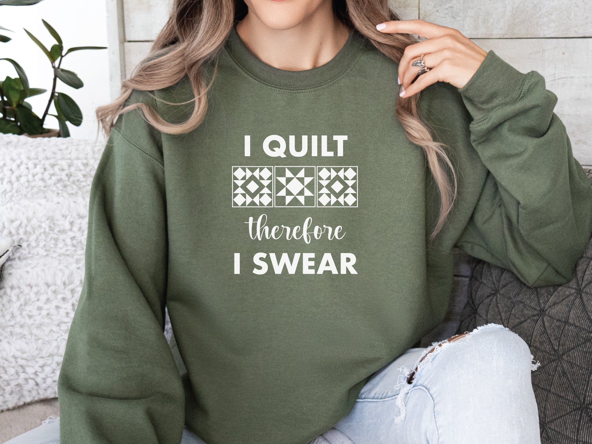 A cozy quilting sweatshirt from Bee Inspired Tees featuring the phrase “I Quilt, Therefore I Swear,” a funny and relatable gift for quilters who love to sew, laugh, and stay warm while stitching.