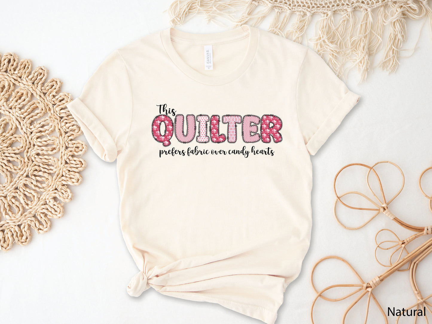 Valentine’s Day quilting t-shirt with the phrase “This Quilter Prefers Fabric Over Candy” in patchwork-style lettering, perfect for quilters.