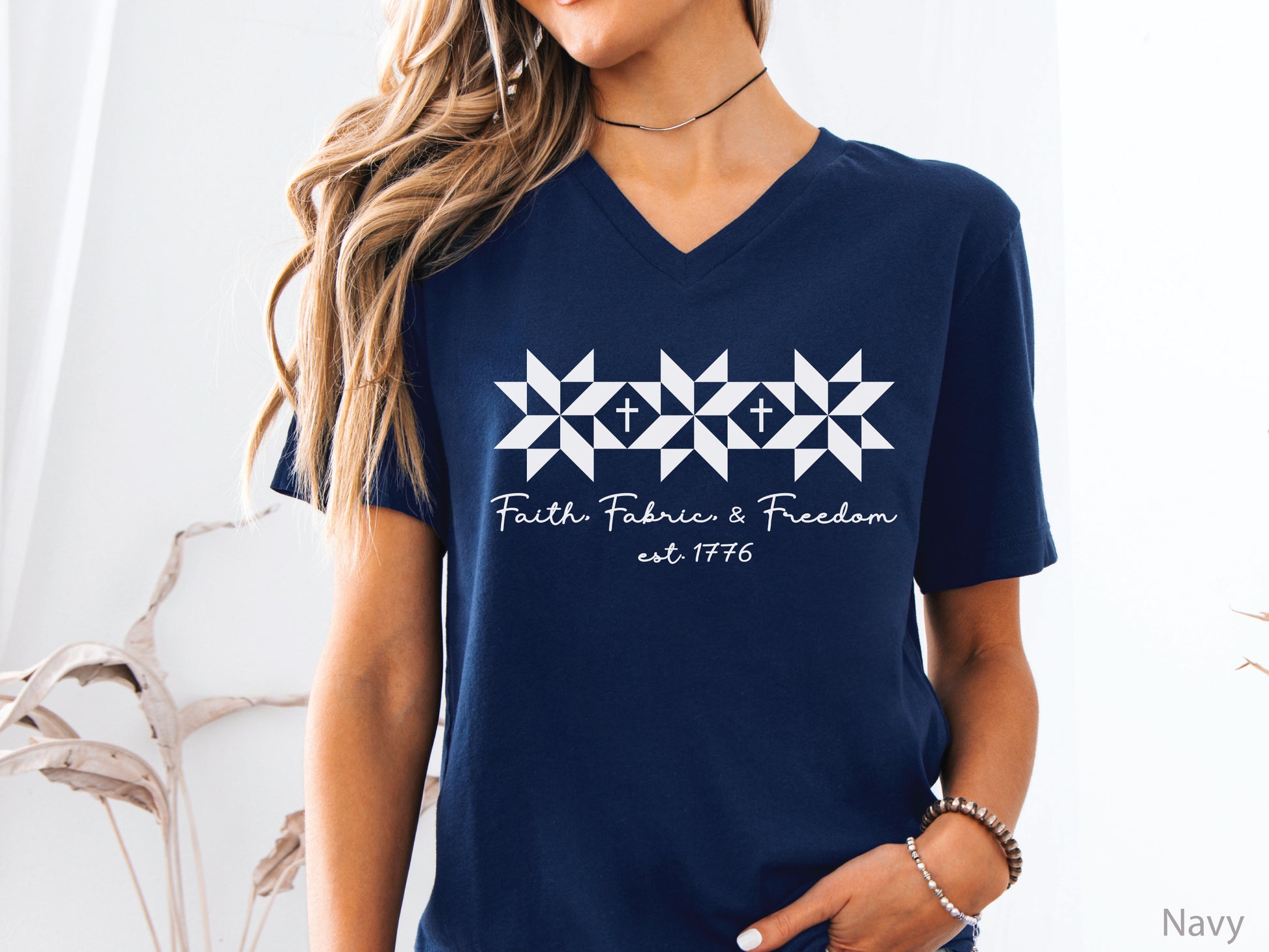 Faith, Fabric & Freedom patriotic v-neck t-shirt with quilt block stars and cross details. Perfect for quilters, sewists, and faith-based gifts.