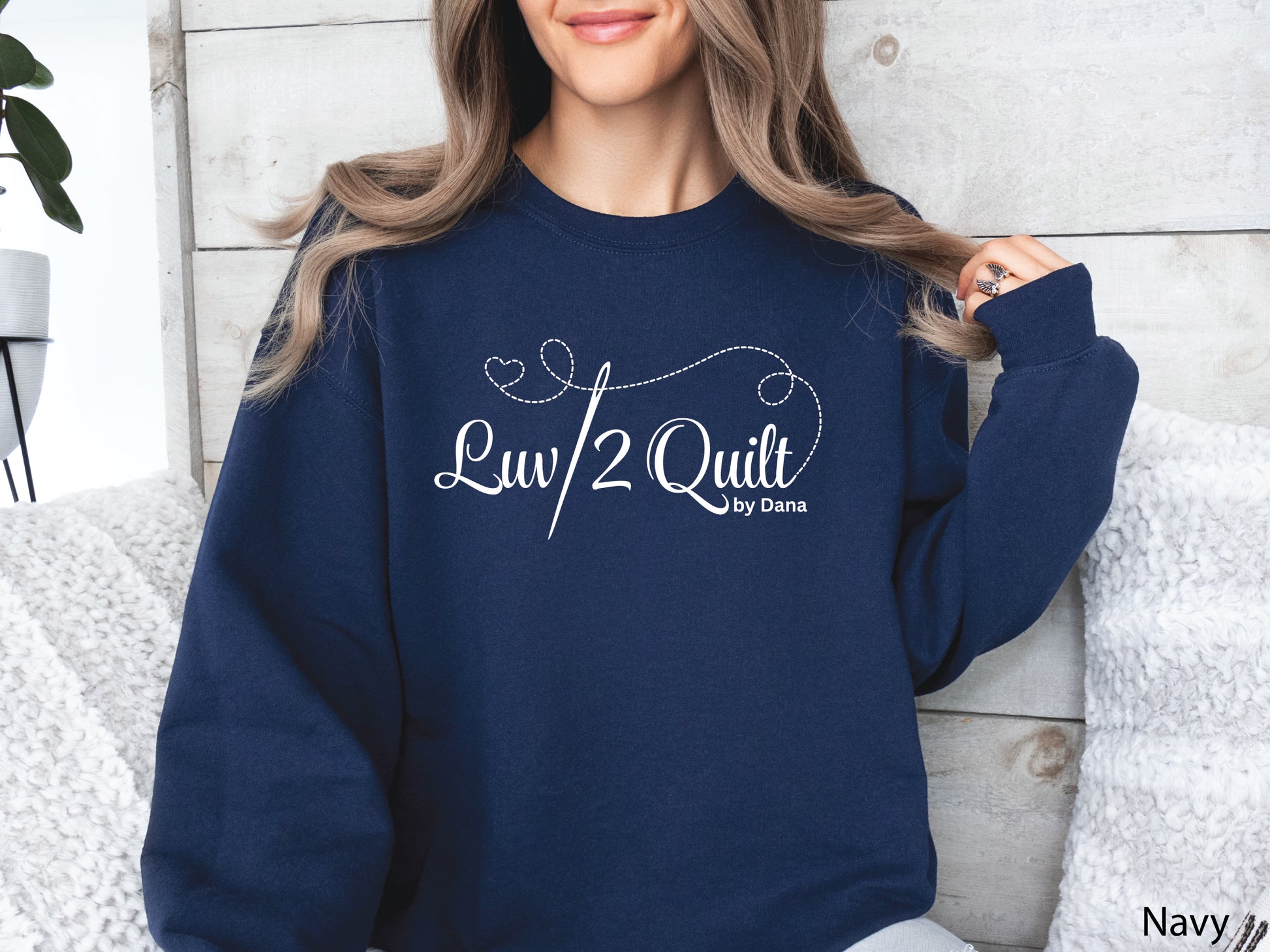 Official Luv2Quilt by Dana quilting-themed sweatshirt featuring the Luv2Quilt logo with a sewing needle and stitched heart design, perfect for quilt classes, retreats, and everyday wear.