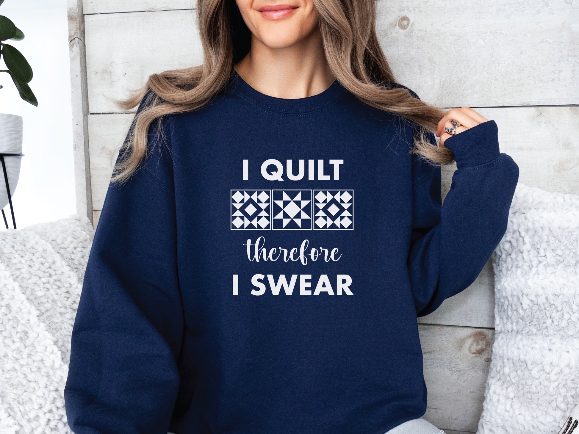 A cozy quilting sweatshirt from Bee Inspired Tees featuring the phrase “I Quilt, Therefore I Swear,” a funny and relatable gift for quilters who love to sew, laugh, and stay warm while stitching.