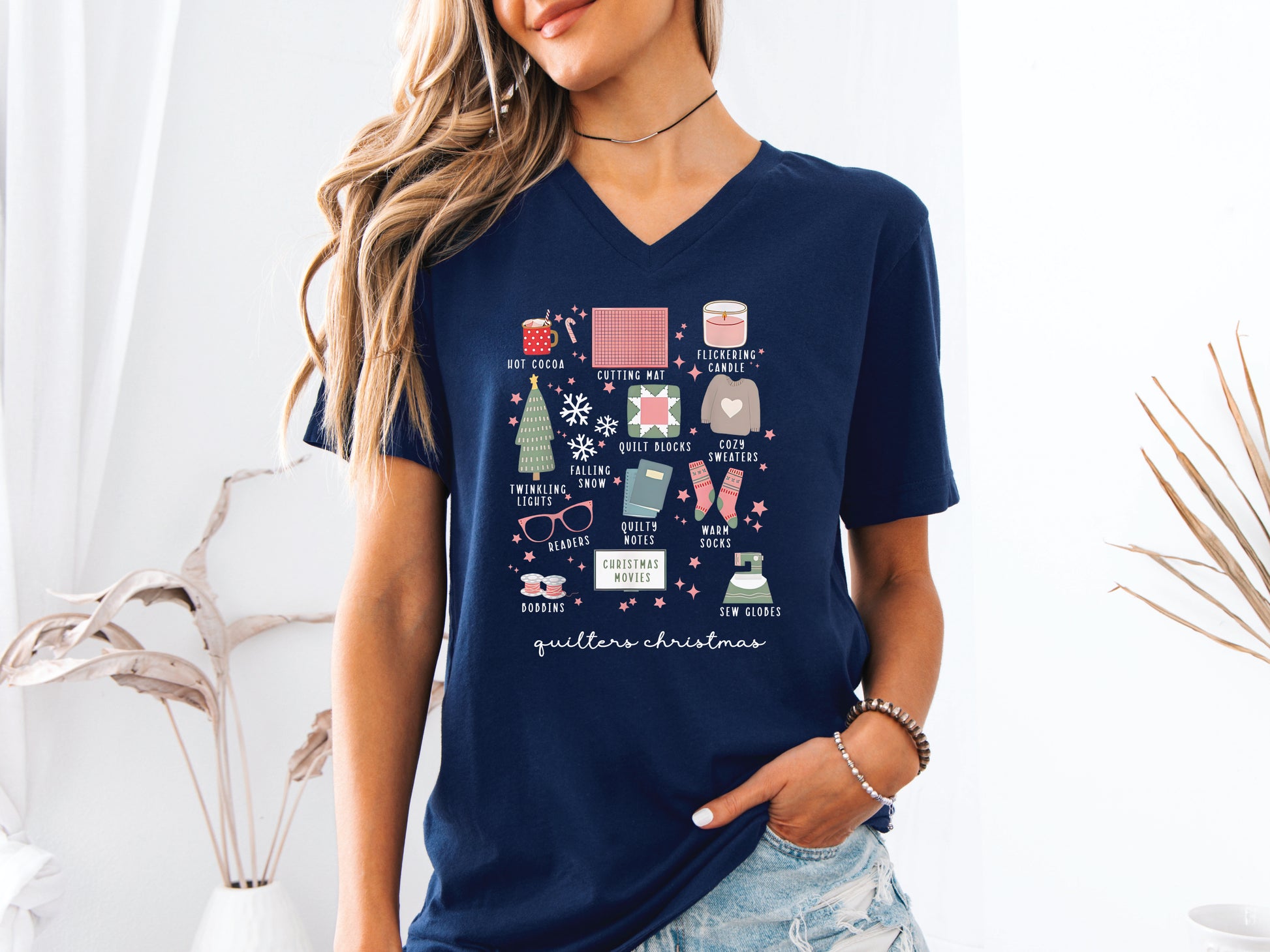 T-shirt with festive “Quilter’s Christmas” icons including quilt blocks, cocoa, lights, sweaters, and sewing items — perfect holiday gift for quilters and sewing lovers.
