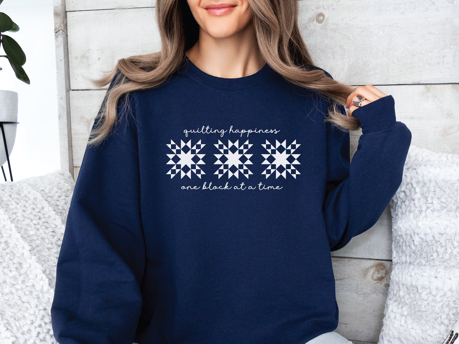 Gildan unisex sweatshirt in Navy with the phrase “Quilting Happiness, One Block at a Time,” designed by Bee Inspired Tees. Cozy fall sweatshirt for quilters, ideal for retreats and gifts for quilting lovers.