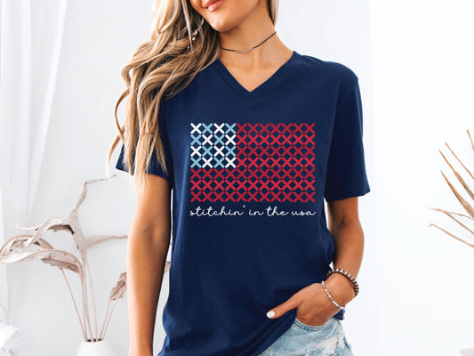 The “Stitchin’ in the USA” is a cross stitch t-shirt in red, white, and blue. The design is "x's" in the shape of a flag. 