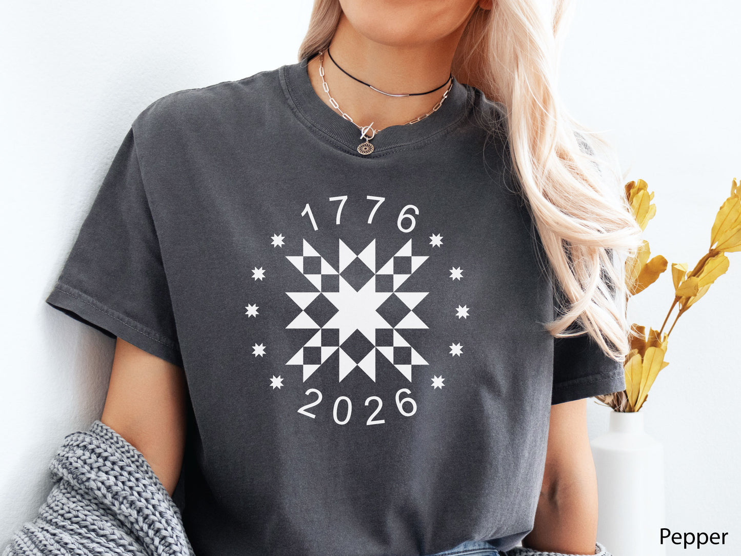 Patriotic quilting t-shirt in navy featuring a white star quilt block with surrounding stars and the years 1776–2026, celebrating America’s 250th Anniversary.
