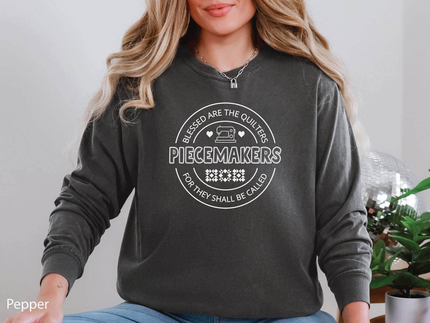 A long-sleeve quilting t-shirt from Bee Inspired Tees featuring the phrase “Piecemaker – Quilters Are Blessed,” celebrating creativity, faith, and the art of quilting; a cozy gift for quilters and perfect for retreats or sewing days.