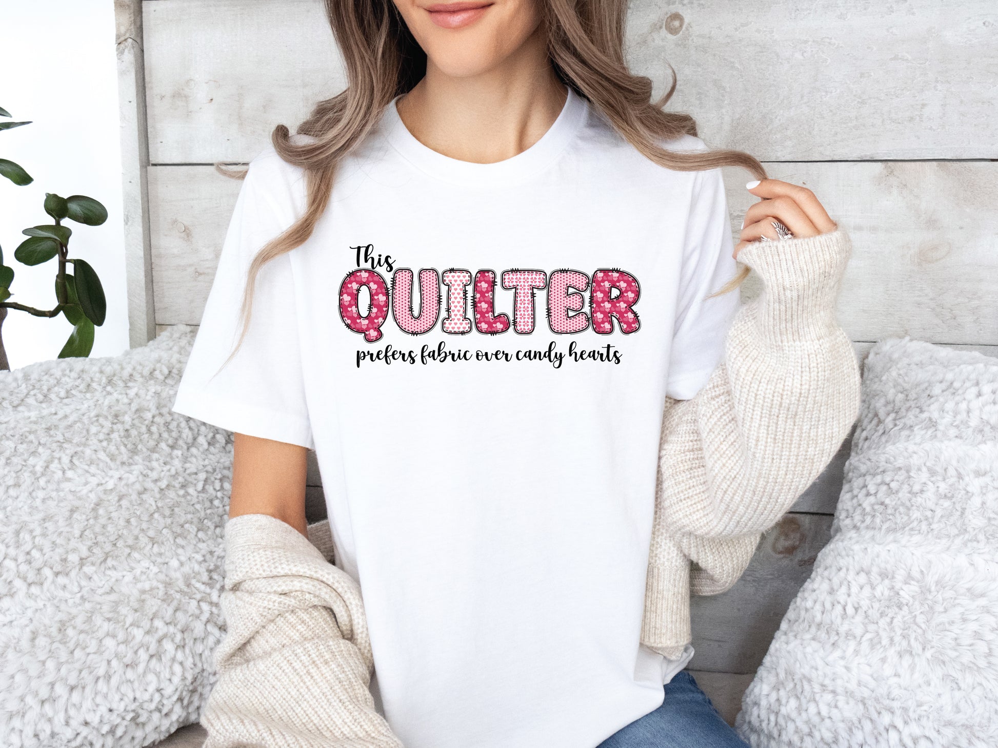 Valentine’s Day quilting t-shirt with the phrase “This Quilter Prefers Fabric Over Candy” in patchwork-style lettering, perfect for quilters.