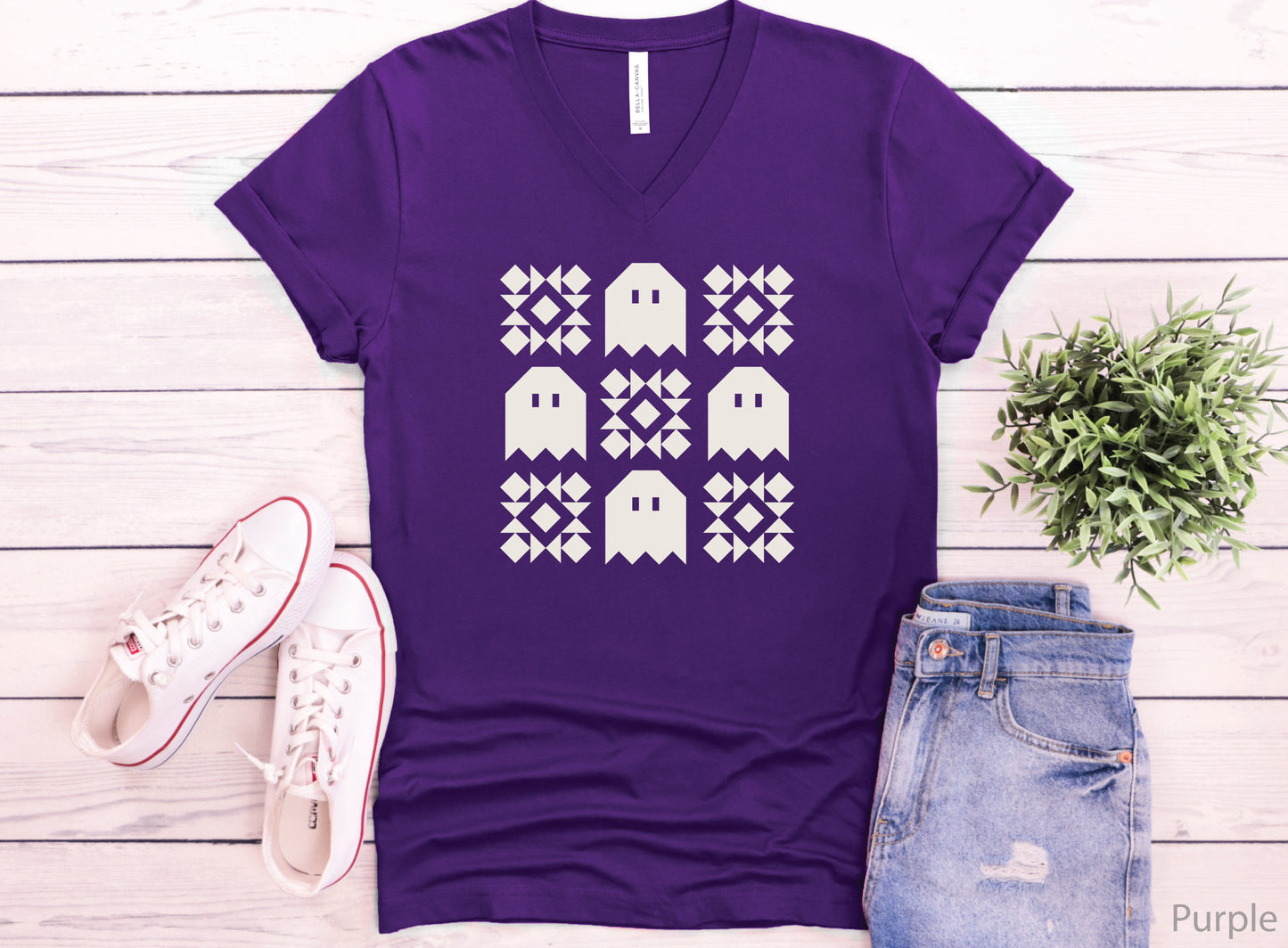 Soft Bella + Canva V-neck Halloween quilting t-shirt featuring a cream grid design with four spooky ghosts and five geometric quilt blocks. A customer favorite!
