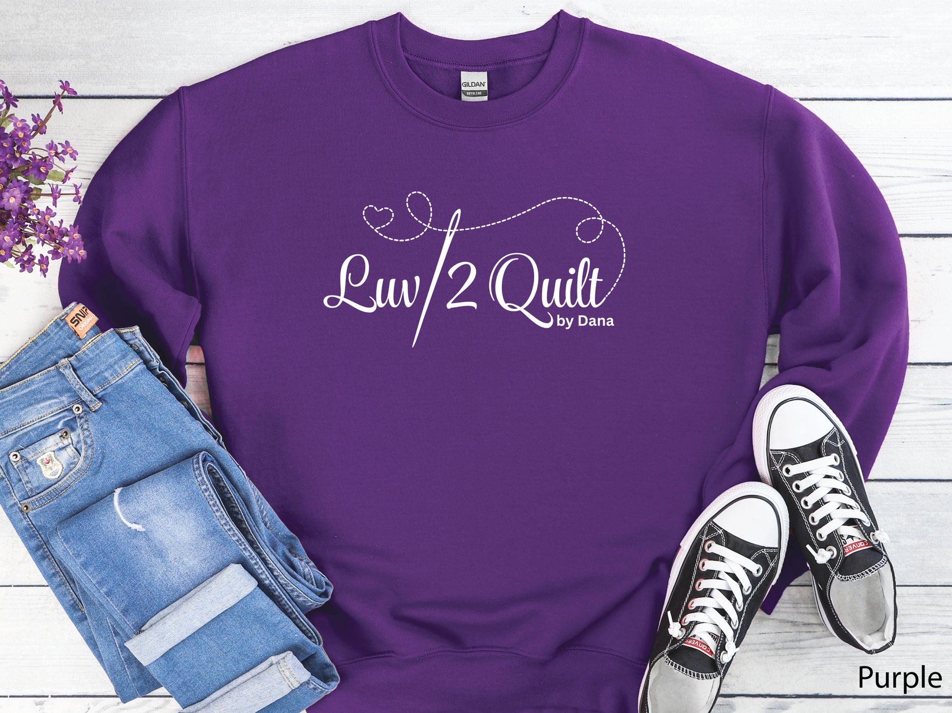 Official Luv2Quilt by Dana quilting-themed sweatshirt featuring the Luv2Quilt logo with a sewing needle and stitched heart design, perfect for quilt classes, retreats, and everyday wear.