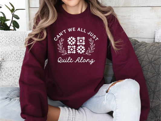 Cozy quilt-themed soft crew Maroon sweatshirt with the phrase “Can’t We Just All Quilt Along,” perfect gift for a quilter, ideal for sewing days, quilt retreats, and craft fairs.
