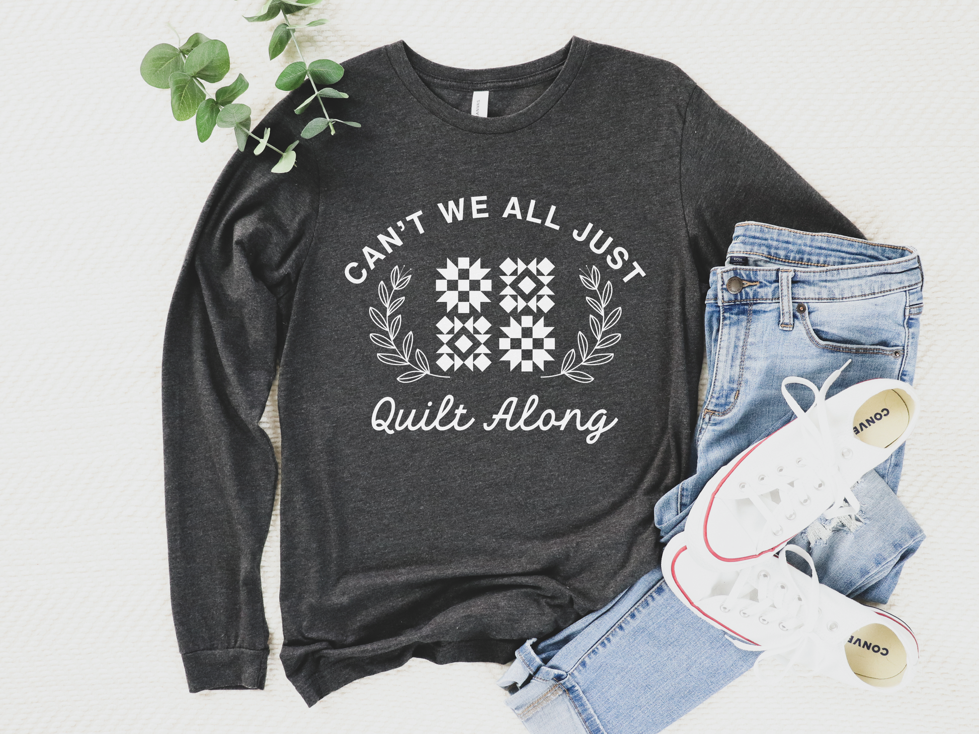 Cozy quilt-themed long sleeve Dark Grey t-shirt with the phrase “Can’t We Just All Quilt Along,” perfect gift for a quilter, ideal for sewing days, quilt retreats, and craft fairs.
