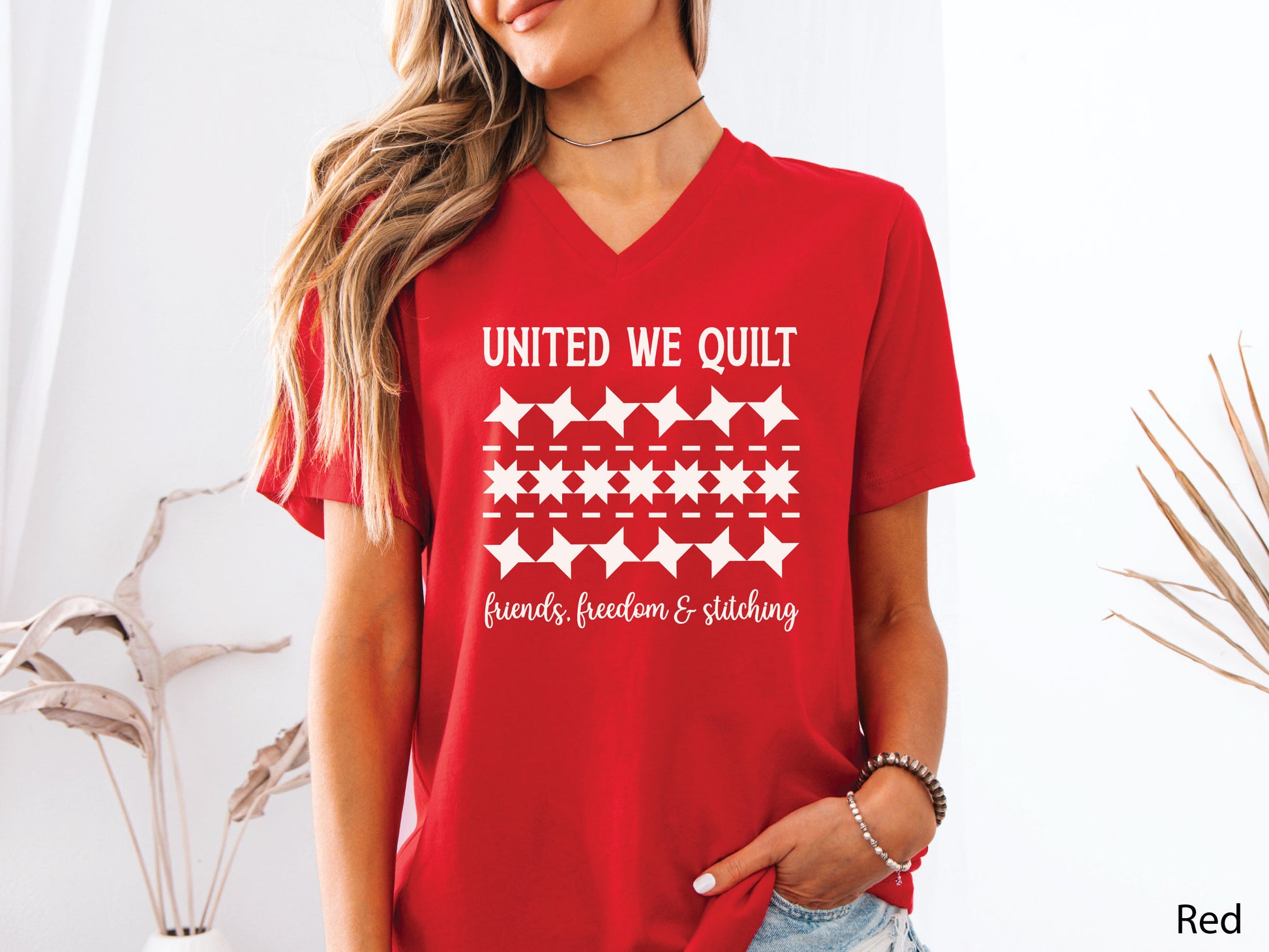 United We Quilt t-shirt with rows of friendship quilt blocks and the phrase Friends, Freedom & Stitching, a fun patriotic shirt for quilters and sewists.
