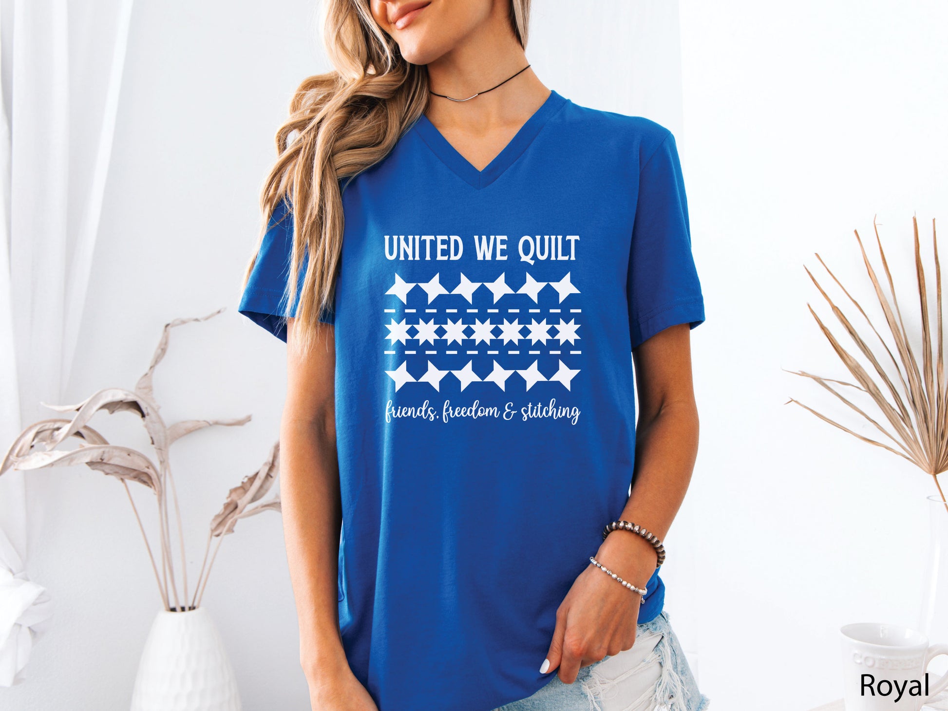 United We Quilt t-shirt with rows of friendship quilt blocks and the phrase Friends, Freedom & Stitching, a fun patriotic shirt for quilters and sewists.