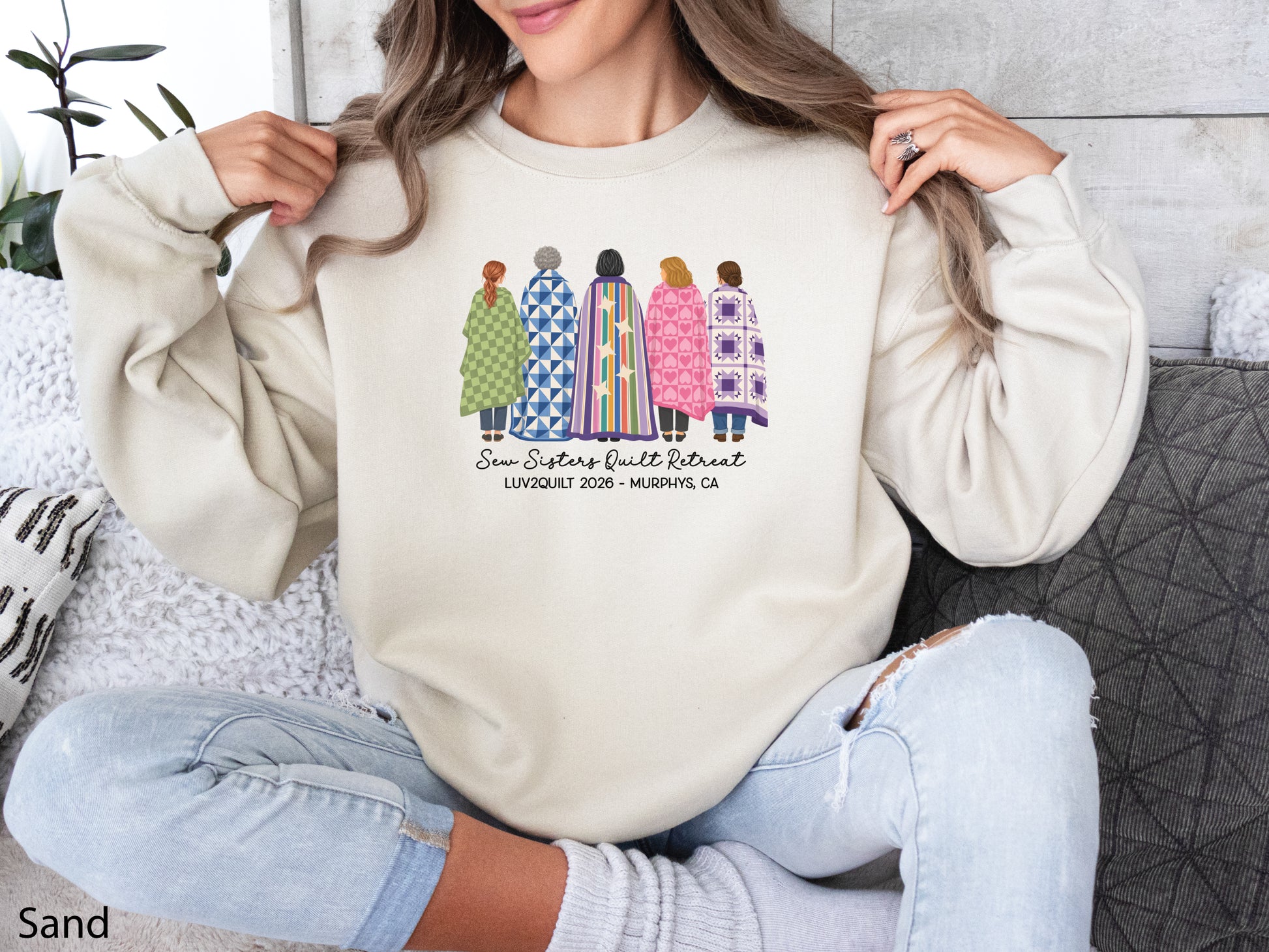 Sew Sisters Quilt Retreat shirt design featuring five women wrapped in colorful green, blue, striped, pink heart, and purple quilts with LUV2QUILT 2026 – Murphys, CA text.