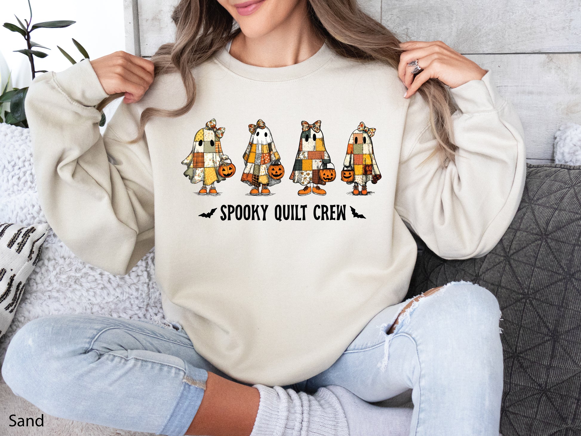 Spooky Quilt Crew sweatshirt from Bee Inspired Tees in the color Sand (Lt. Beige), featuring four patchwork ghosts with jack-o’-lanterns and bold text—fun Halloween gift for quilters.