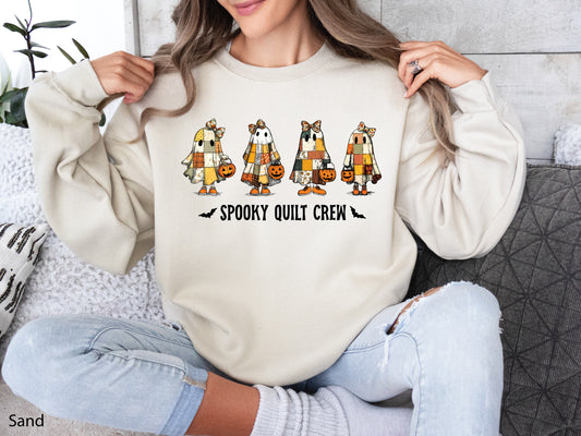 Spooky Quilt Crew sweatshirt from Bee Inspired Tees in the color Sand (Lt. Beige), featuring four patchwork ghosts with jack-o’-lanterns and bold text—fun Halloween gift for quilters.