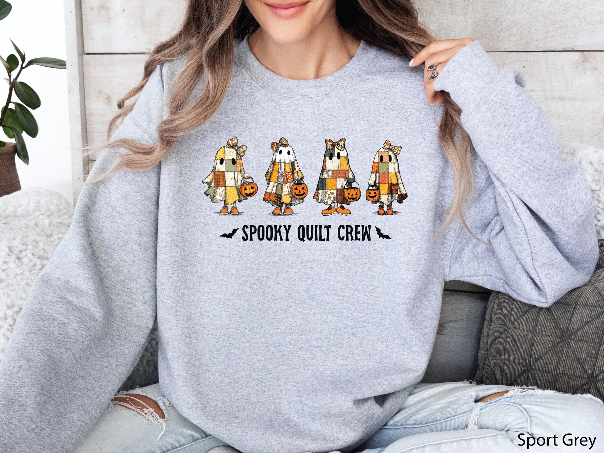 Spooky Quilt Crew sweatshirt from Bee Inspired Tees in the color Sport Grey, featuring four patchwork ghosts with jack-o’-lanterns and bold text—fun Halloween gift for quilters.