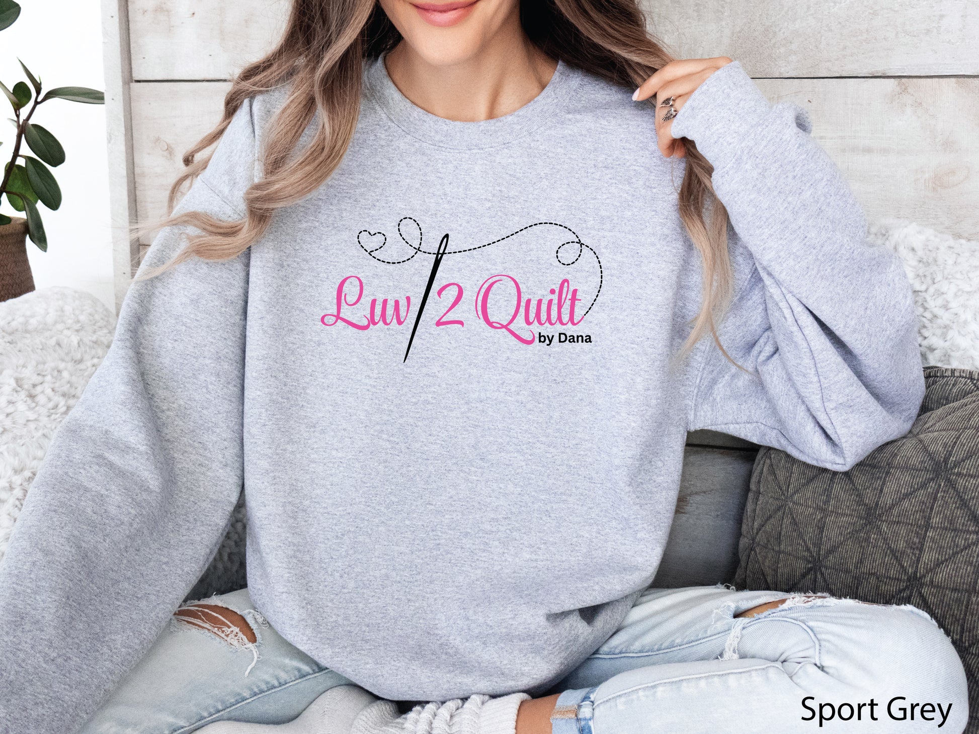 Official Luv2Quilt by Dana quilting-themed sweatshirt featuring the Luv2Quilt logo with a sewing needle and stitched heart design, perfect for quilt classes, retreats, and everyday wear.