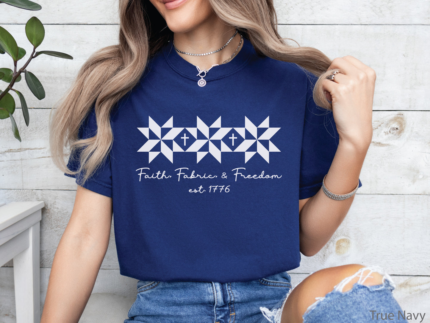 Blue t-shirt with Faith, Fabric & Freedom design featuring quilt star blocks with cross details, ideal for quilters and faith-based patriotic wear.