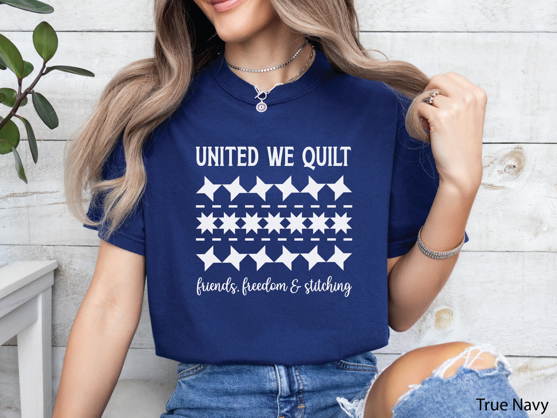 United We Quilt t-shirt with rows of friendship quilt blocks and the phrase Friends, Freedom & Stitching, a fun patriotic shirt for quilters and sewists.