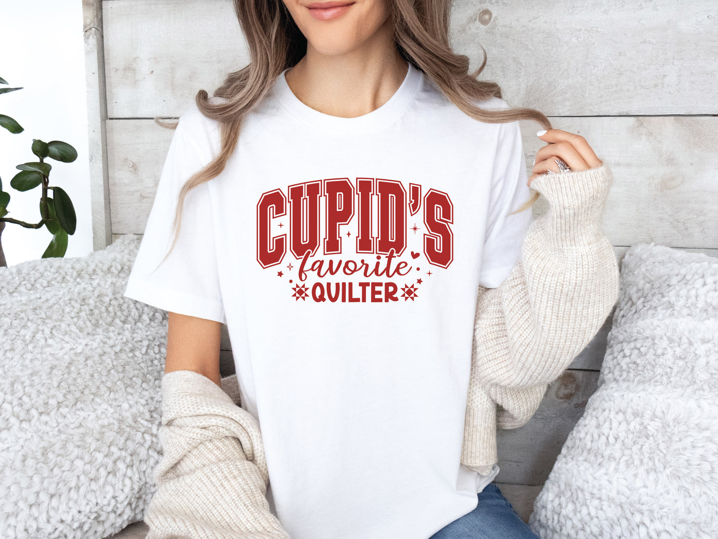 Valentine’s Day quilting t-shirt with “Cupid’s Favorite Quilter” phrase in varsity-style lettering and quilt-inspired details, perfect for quilters.