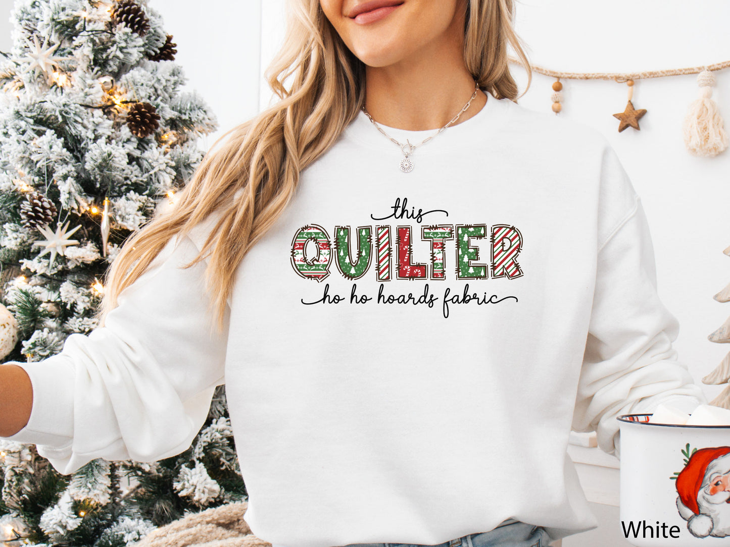 Cozy sweatshirt with playful patchwork lettering that says “This Quilter Ho Ho Hoards Fabric” — festive Christmas gift for quilters and sewing enthusiasts.