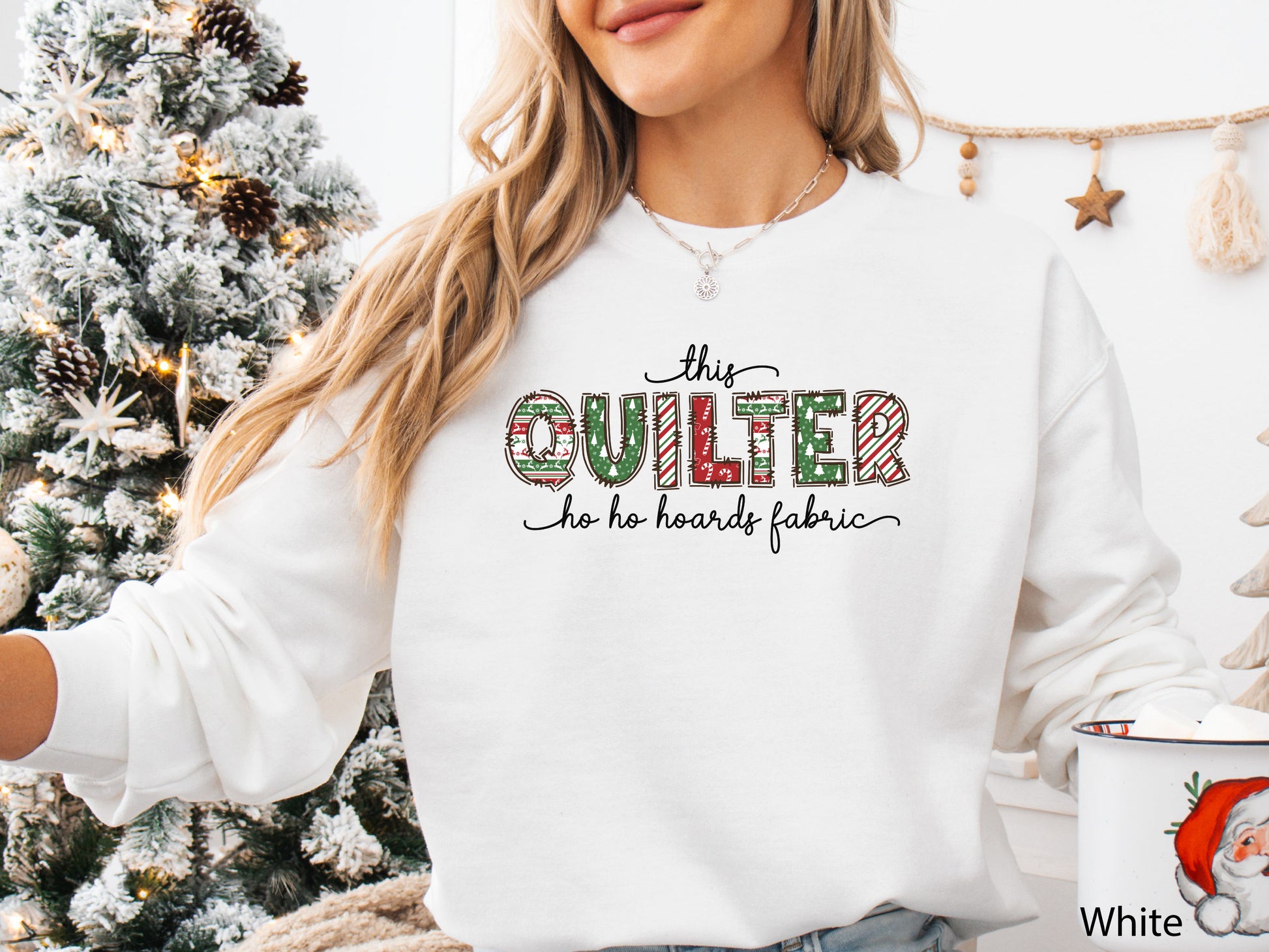 Cozy sweatshirt with playful patchwork lettering that says “This Quilter Ho Ho Hoards Fabric” — festive Christmas gift for quilters and sewing enthusiasts.