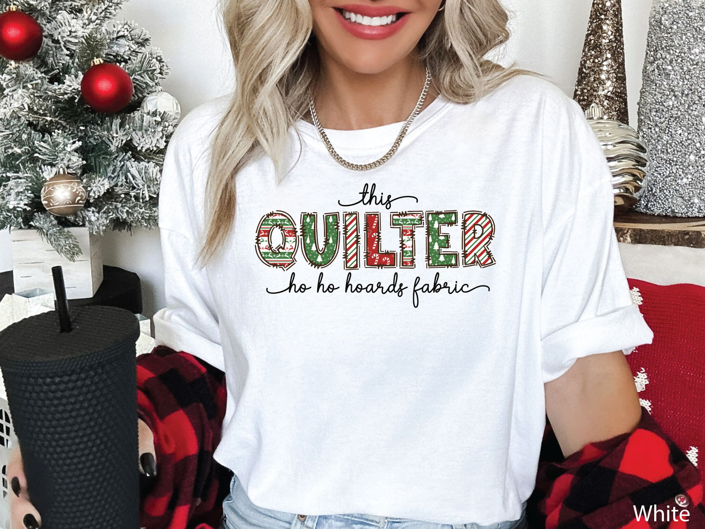 This Quilter Ho Ho Hoards Fabric t-shirt with red and green patchwork lettering, a funny Christmas shirt for quilters who love fabric, sewing, and holiday cheer.
