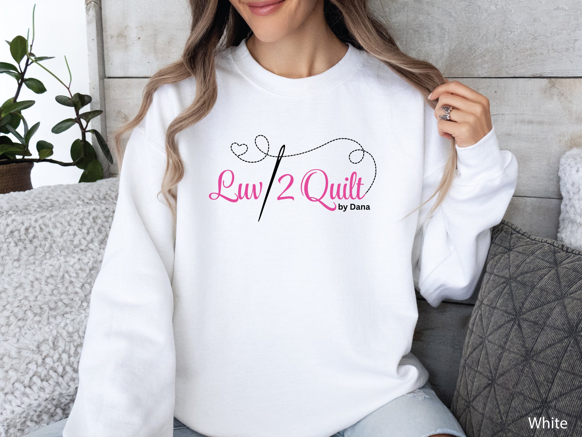 Official Luv2Quilt by Dana quilting-themed sweatshirt featuring the Luv2Quilt logo with a sewing needle and stitched heart design, perfect for quilt classes, retreats, and everyday wear.