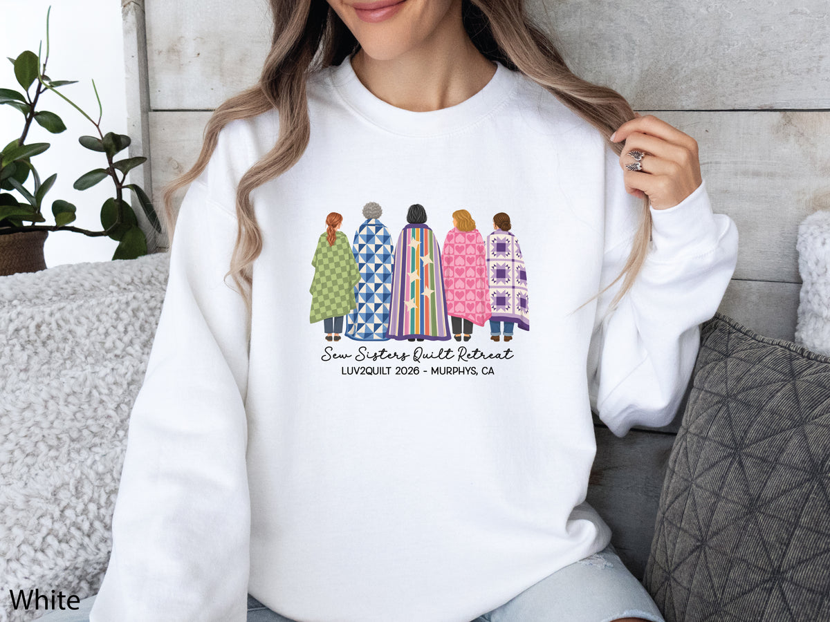 Sew Sisters Quilt Retreat shirt design featuring five women wrapped in colorful green, blue, striped, pink heart, and purple quilts with LUV2QUILT 2026 – Murphys, CA text.