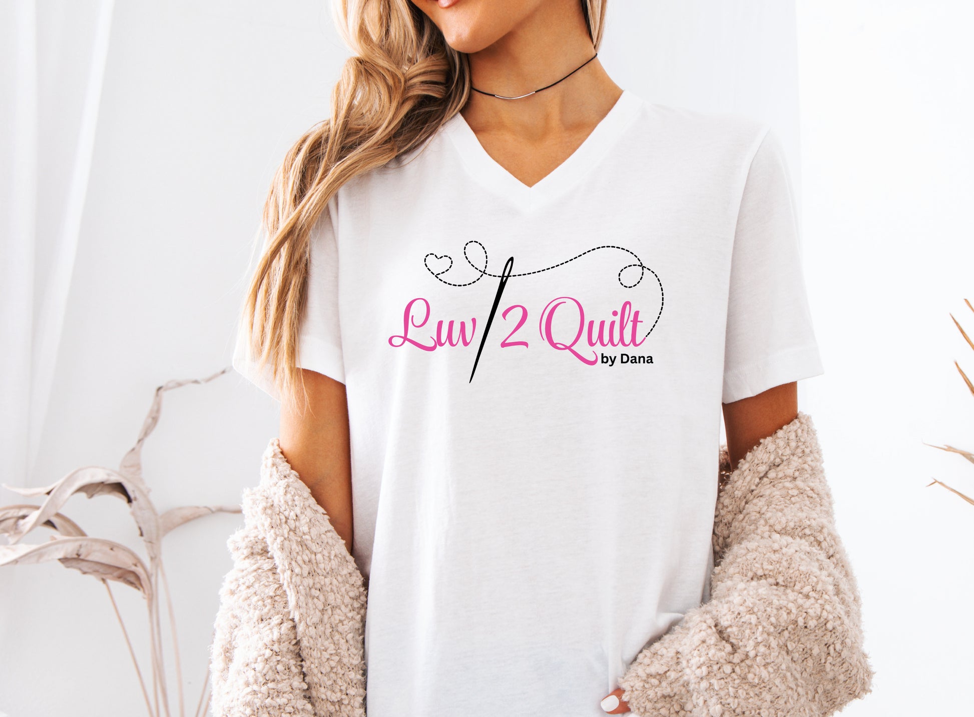 Official Luv2Quilt by Dana quilting-themed t-shirt featuring the Luv2Quilt logo with a sewing needle and stitched heart design, perfect for quilt classes, retreats, and everyday wear.