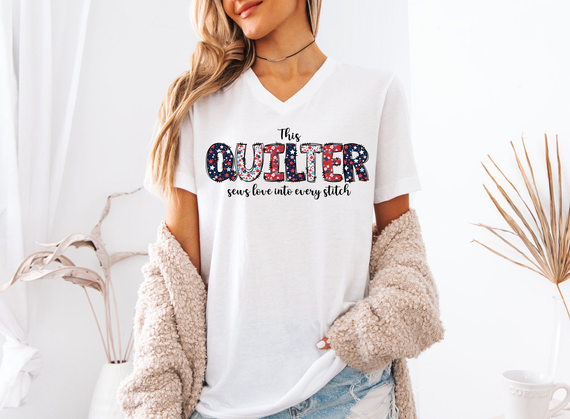 Patriotic quilting t-shirt with the phrase “This Quilter Sews Love Into Every Stitch” in red, white, and blue patchwork lettering, perfect for celebrating America’s 250th Anniversary.
