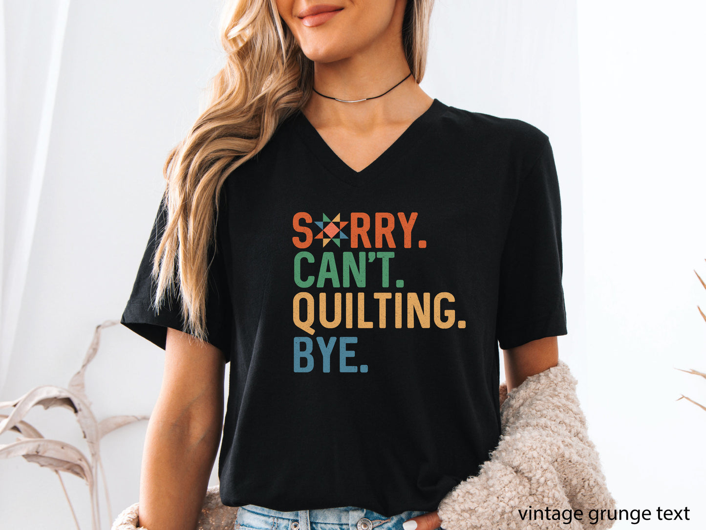 Funny “Sorry, Can’t. Quilting. Bye.” V-neck T-shirt with distressed vintage-style lettering, shown on a black shirt — a humorous gift for sewing and quilting lovers.