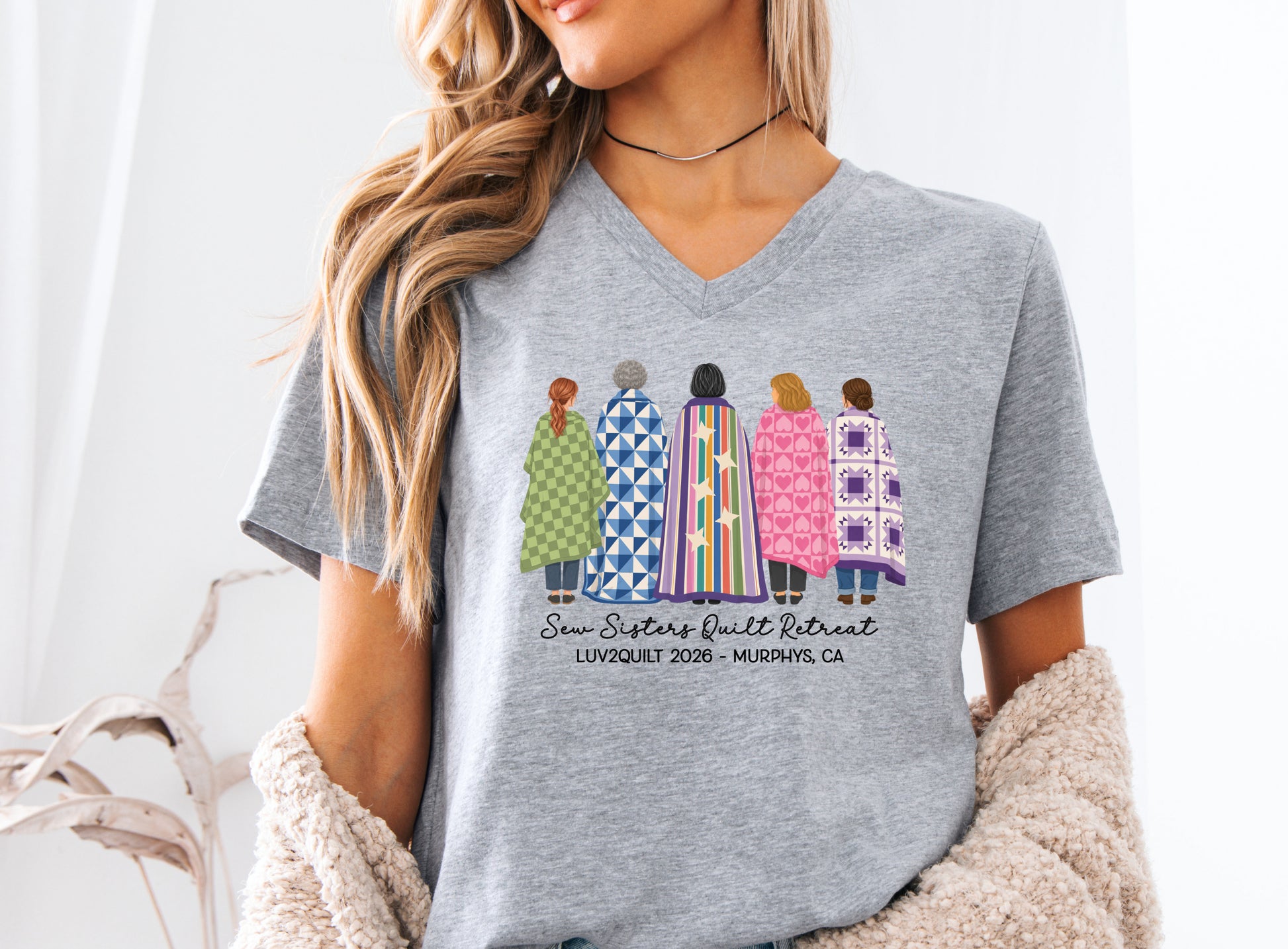 Sew Sisters Quilt Retreat shirt design featuring five women wrapped in colorful green, blue, striped, pink heart, and purple quilts with LUV2QUILT personalized text.