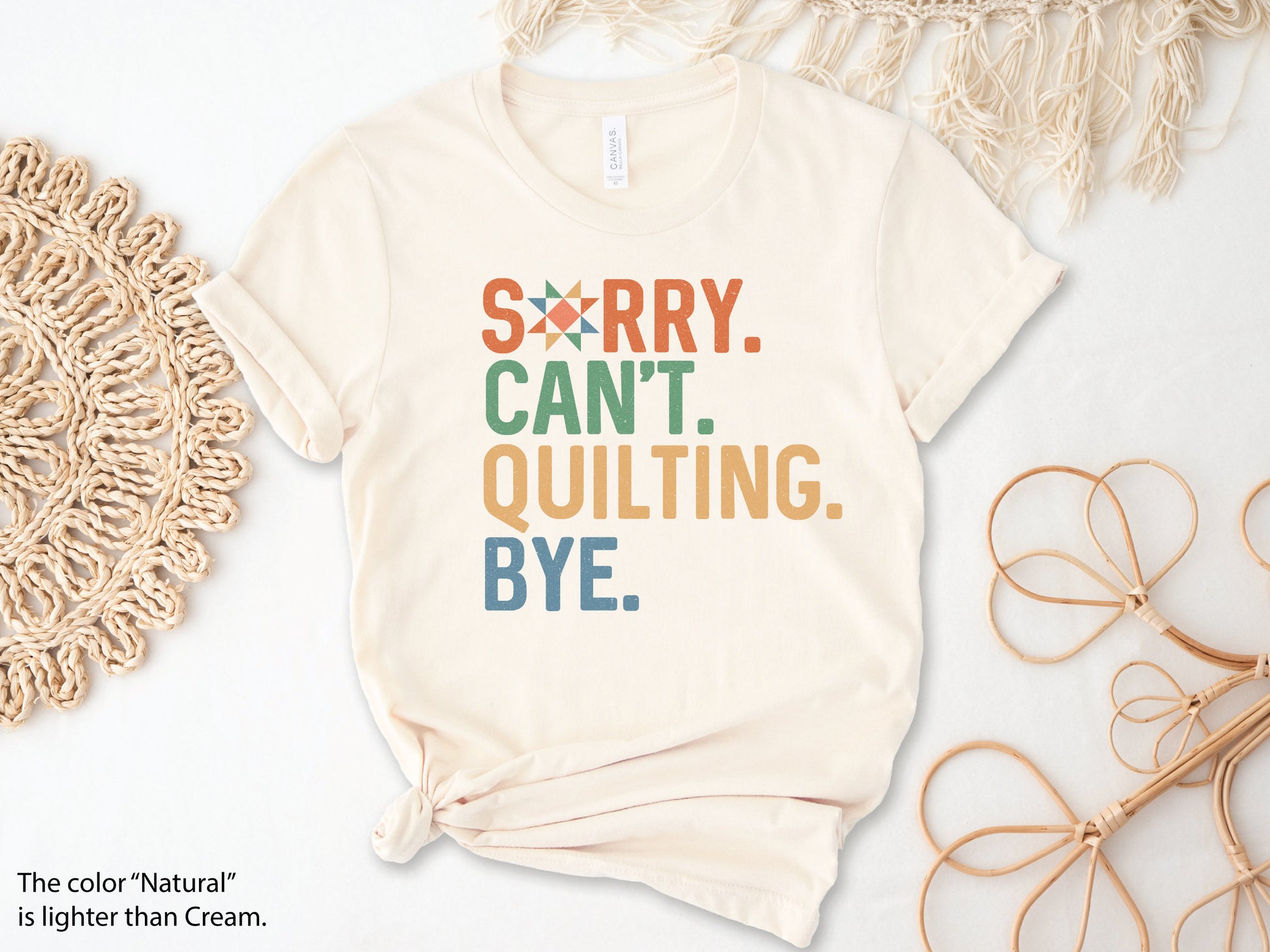 The (distressed style) text on this ladies t-shirt reads Sorry Cant Quilting Bye. Each word has a colorful color text (Orange, Green, Yellow and Blue). Quilt star in the O in Sorry.
