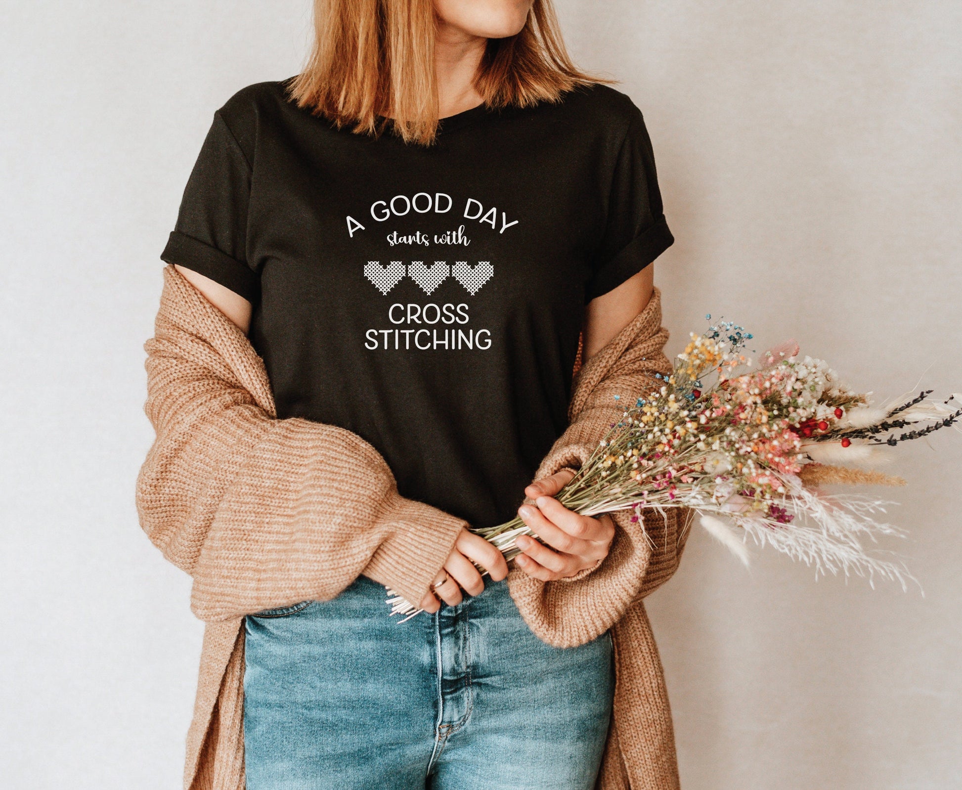 A Good Day Starts With Cross Stitching shirt, with 3 hearts printed on a black shirt.